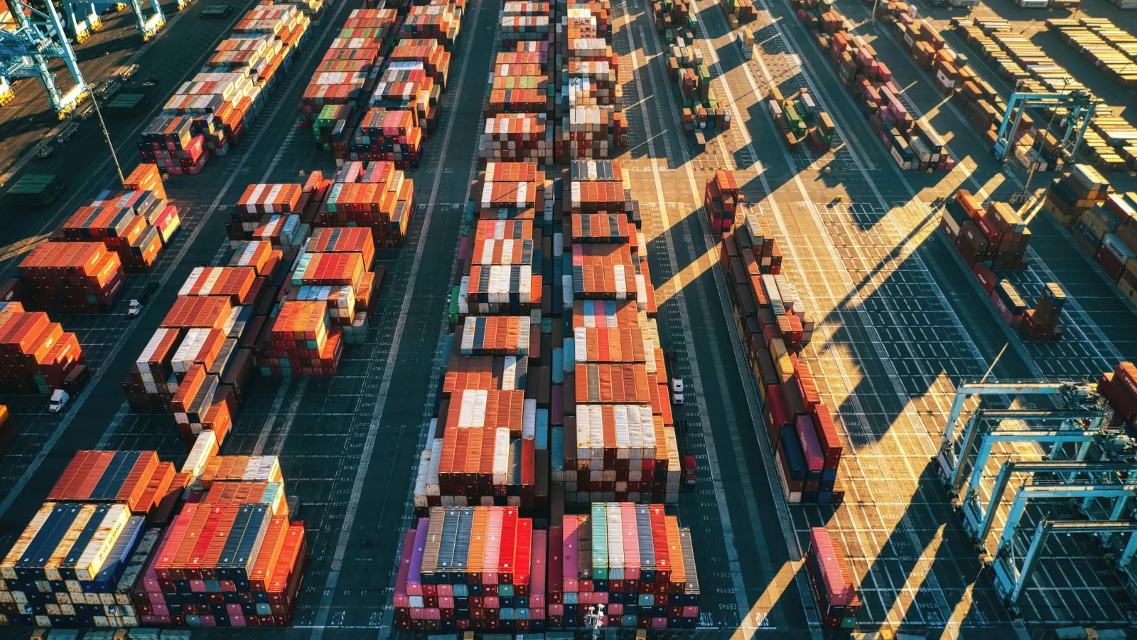 Aerial view of stacked shipping containers in a port container yard