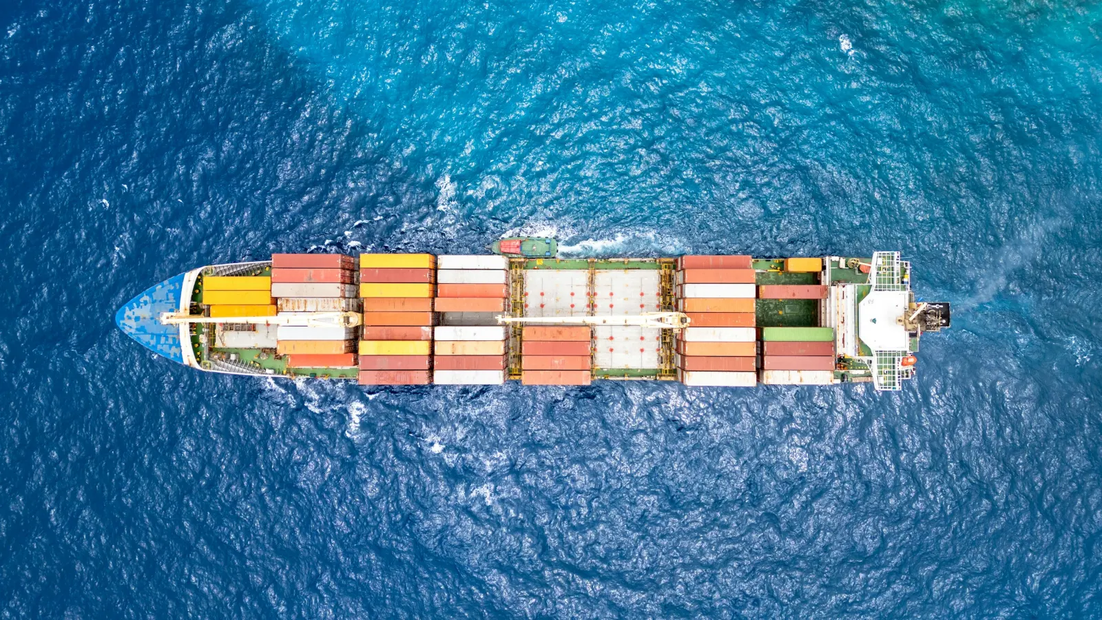 Aerial view of a laden container ship sailing on open sea